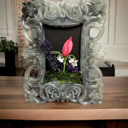 Old fashion grey frame with flower arrangement