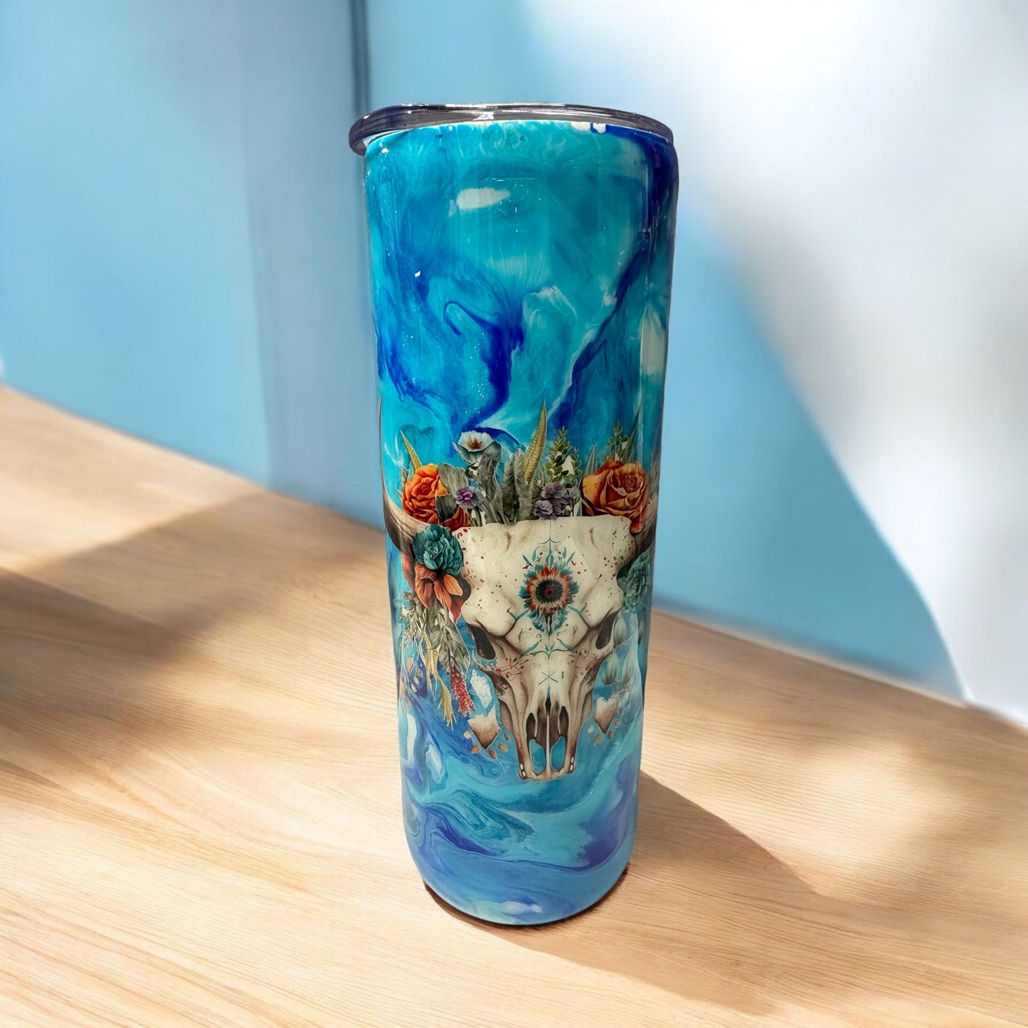 Cow skull 20 oz tumbler with blue background